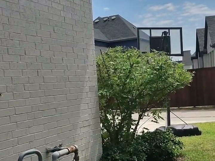A driveway and garage apron after a Curb Appeal power wash, concrete back to its real color